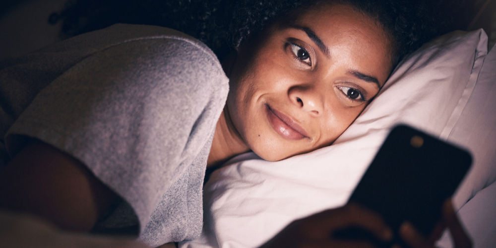 Woman using smartphone showcasing blue light radiation
