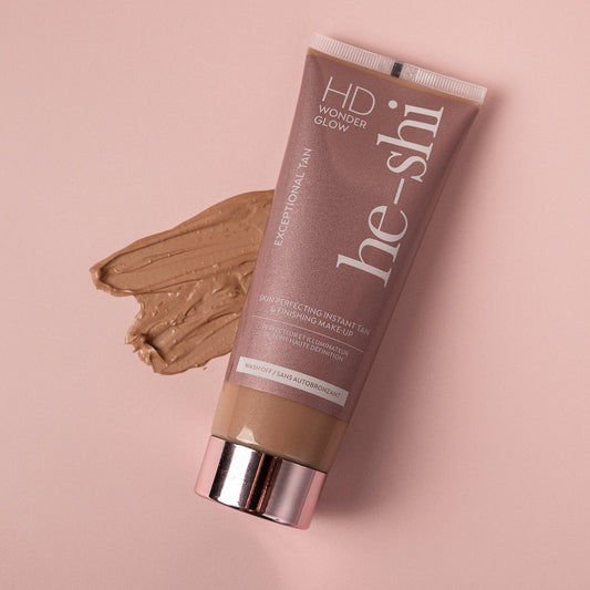 Image of HD Wonder Glow tube lying on its side with a cream texture of the product beside it