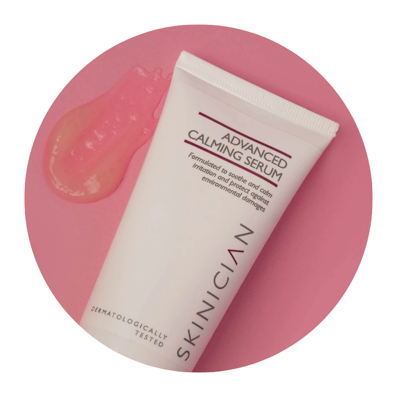 Round image of Skinician Advanced Calming Serum tube lying on a red background with the serum texture beside it