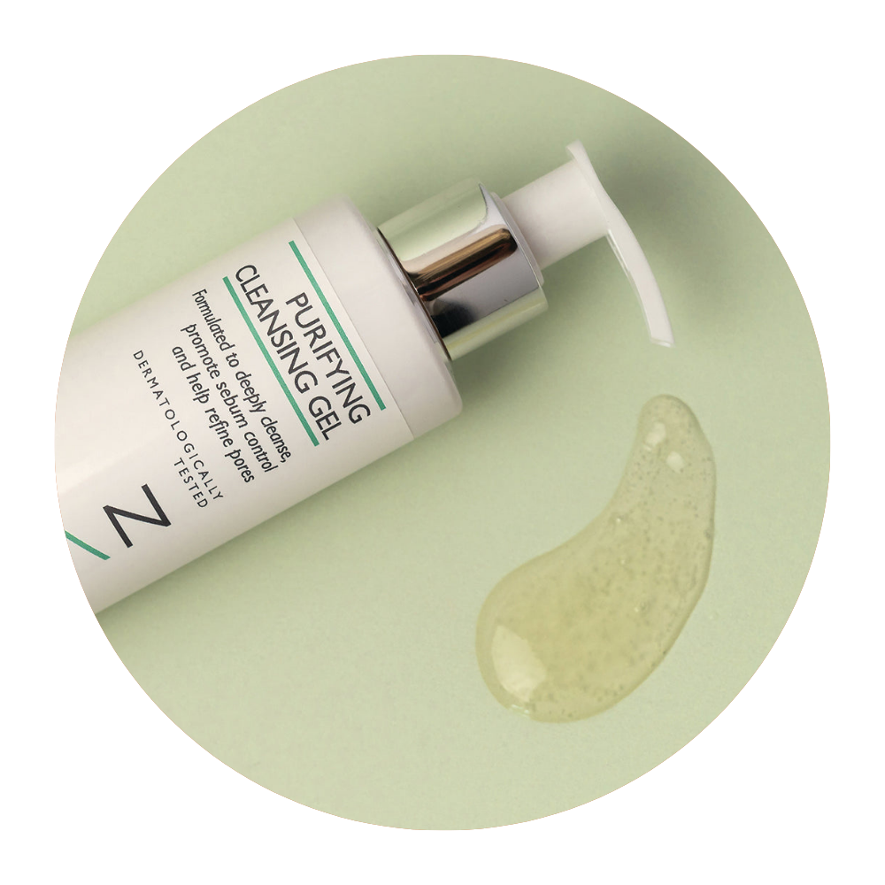 Image of Purifying Cleansing Gel bottle lying on its side on a light green background with the gel cleanser product pouring out