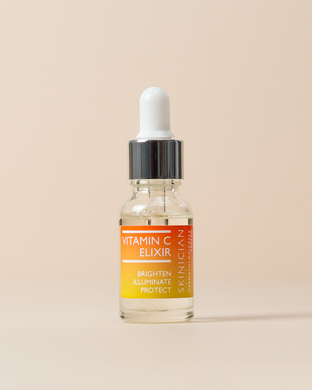Vitamin C elixir bottle with dropper on a beige background