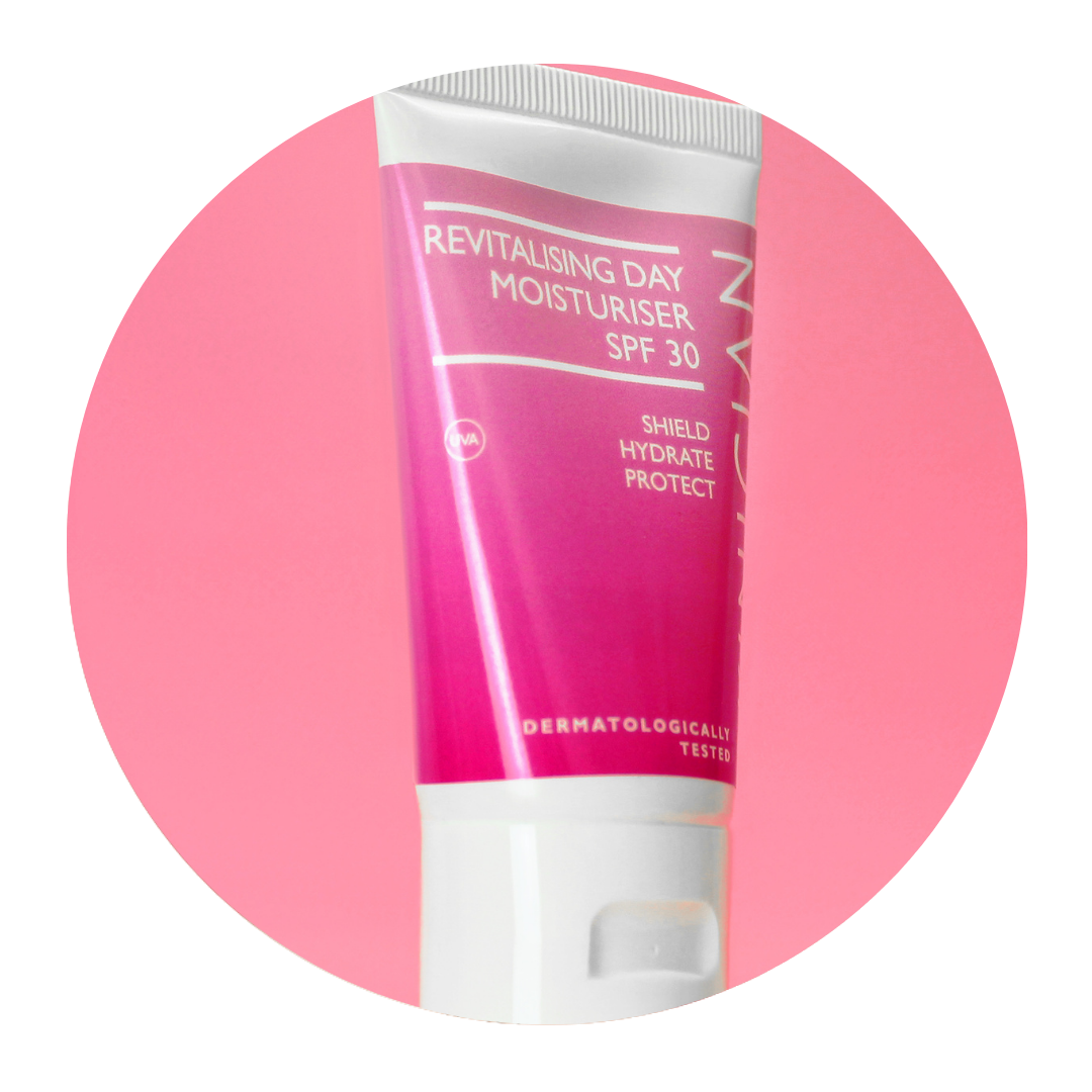 Round image of Skinician Revitalising Day Moisturiser tube on a pink background