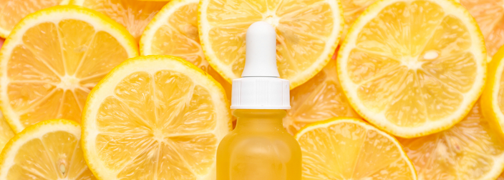 Image of skincare bottle surrounded by sliced lemons