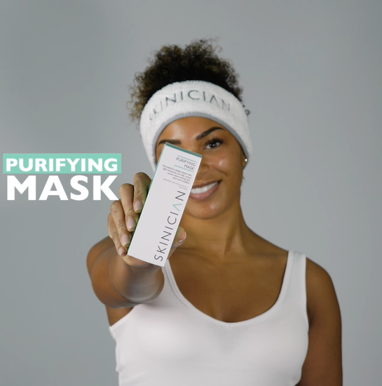 A youtube video of a lady opening the box and applying the purifying mask to her face.