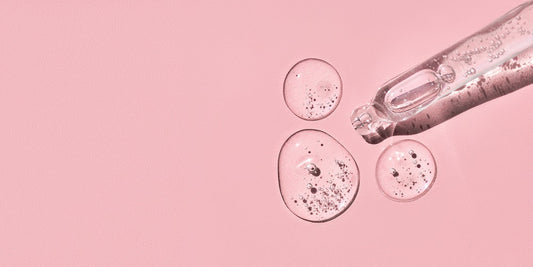 image of pipette and hyaluronic acid drops on pink background