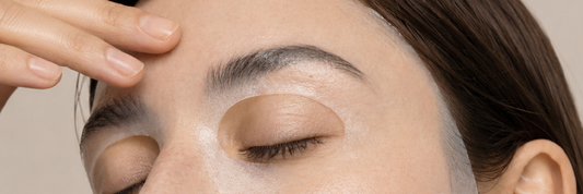 Image close up of woman wearing the Ceramide Sheet mask touching her face with her fingers