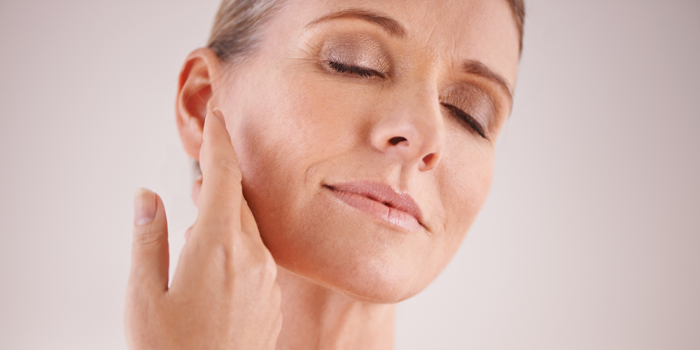 Image of older women touching her face