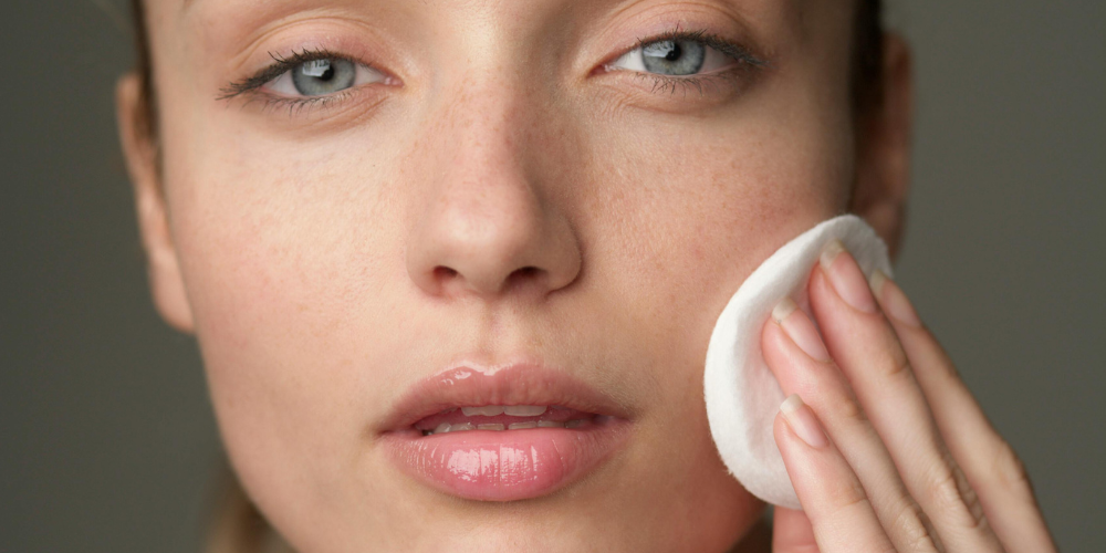 Picture of woman applying Glycolic Acid Exfoliating Toner to her face after cleansing