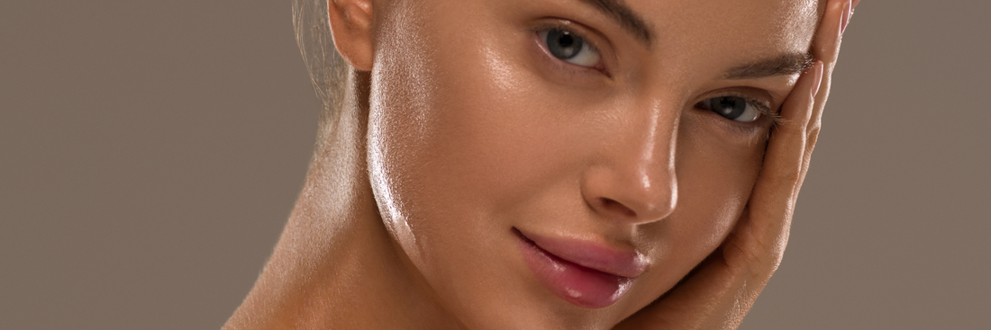 A woman holding her hand to the side of her face, with a soft smile, looking at the front.
