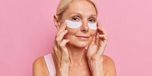 woman applying eye mask patches