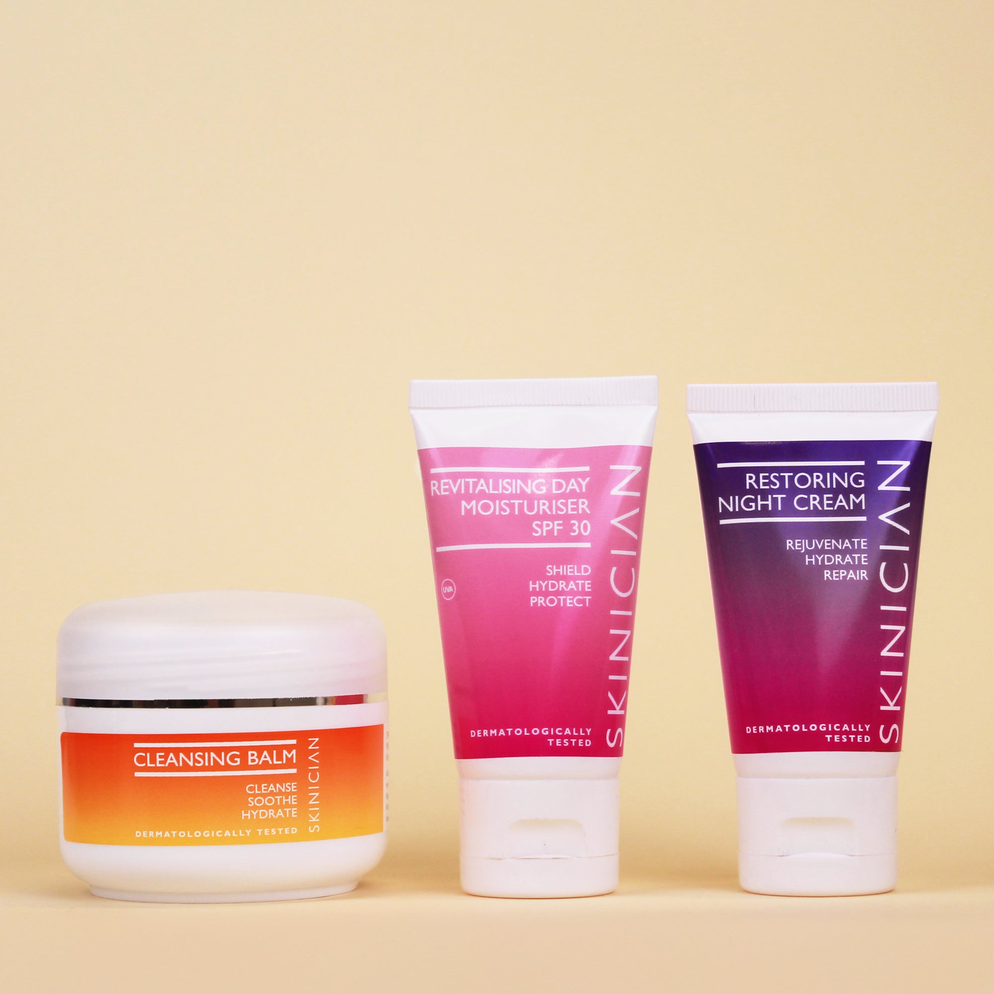 Image of Skinician Cleansing Balm, Revitalising Day Moisturiser and Restoring Night Cream on a cream background
