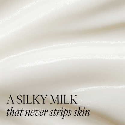 Close-up of smooth, white cream texture of Revitalising Cleanser with text "a silky milk that never strips skin"