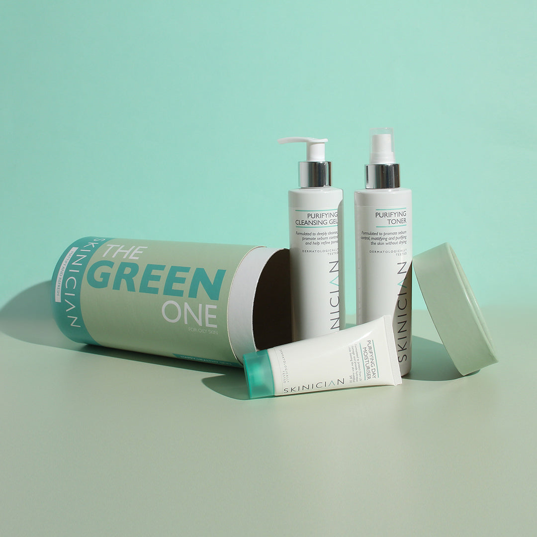 Image showing SKINICIAN Green One Gift Set box lying on it's side with products next to it