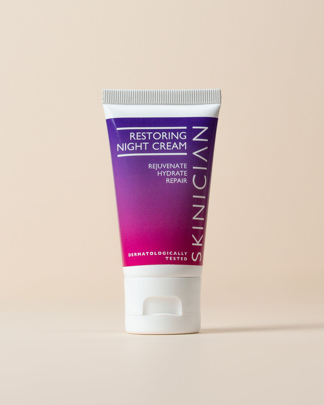 Tube of Skinician Restoring Night Cream on a beige background
