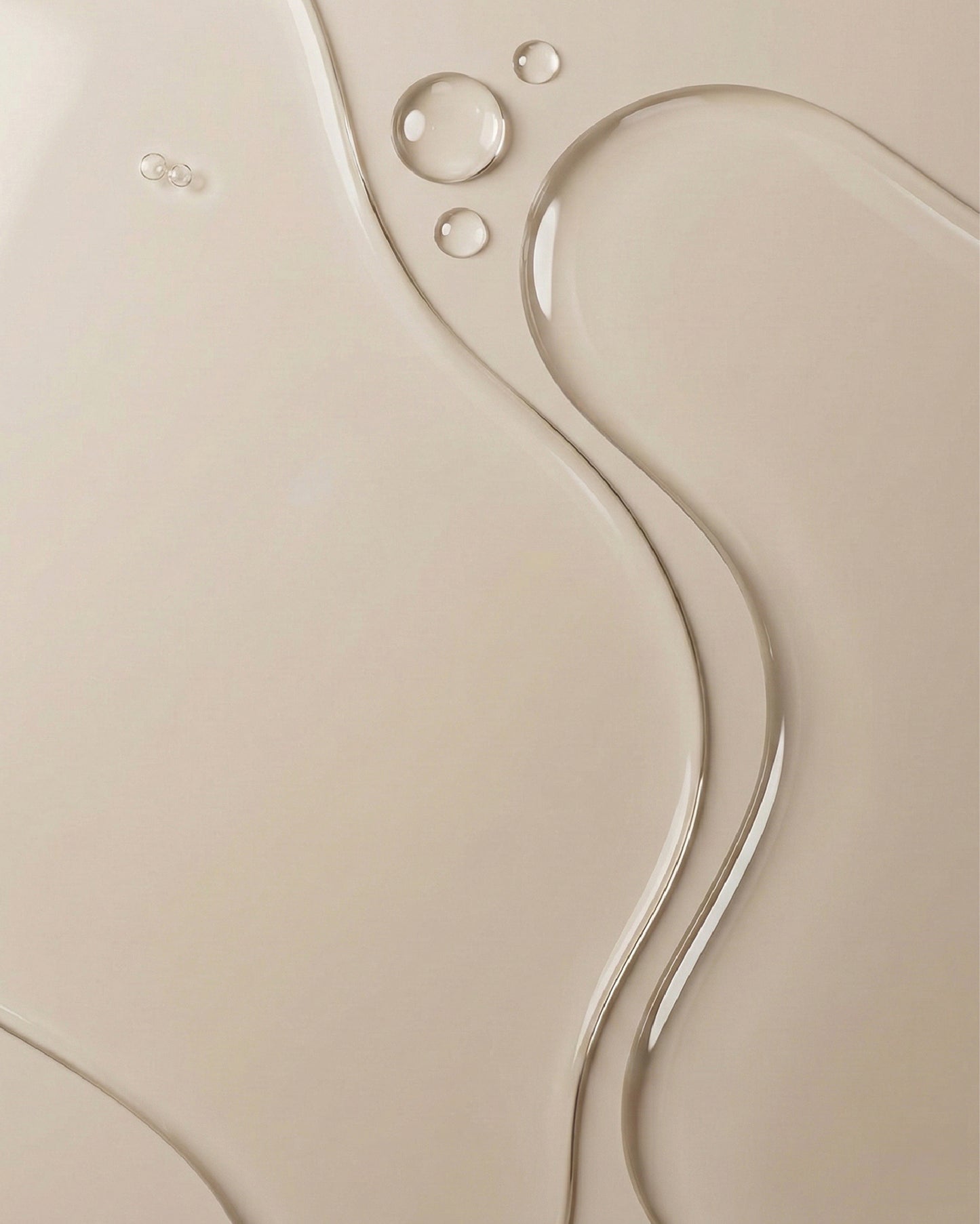 Close up image showing the liquid texture of Glycolic Exfoliating Toner on beige surface
