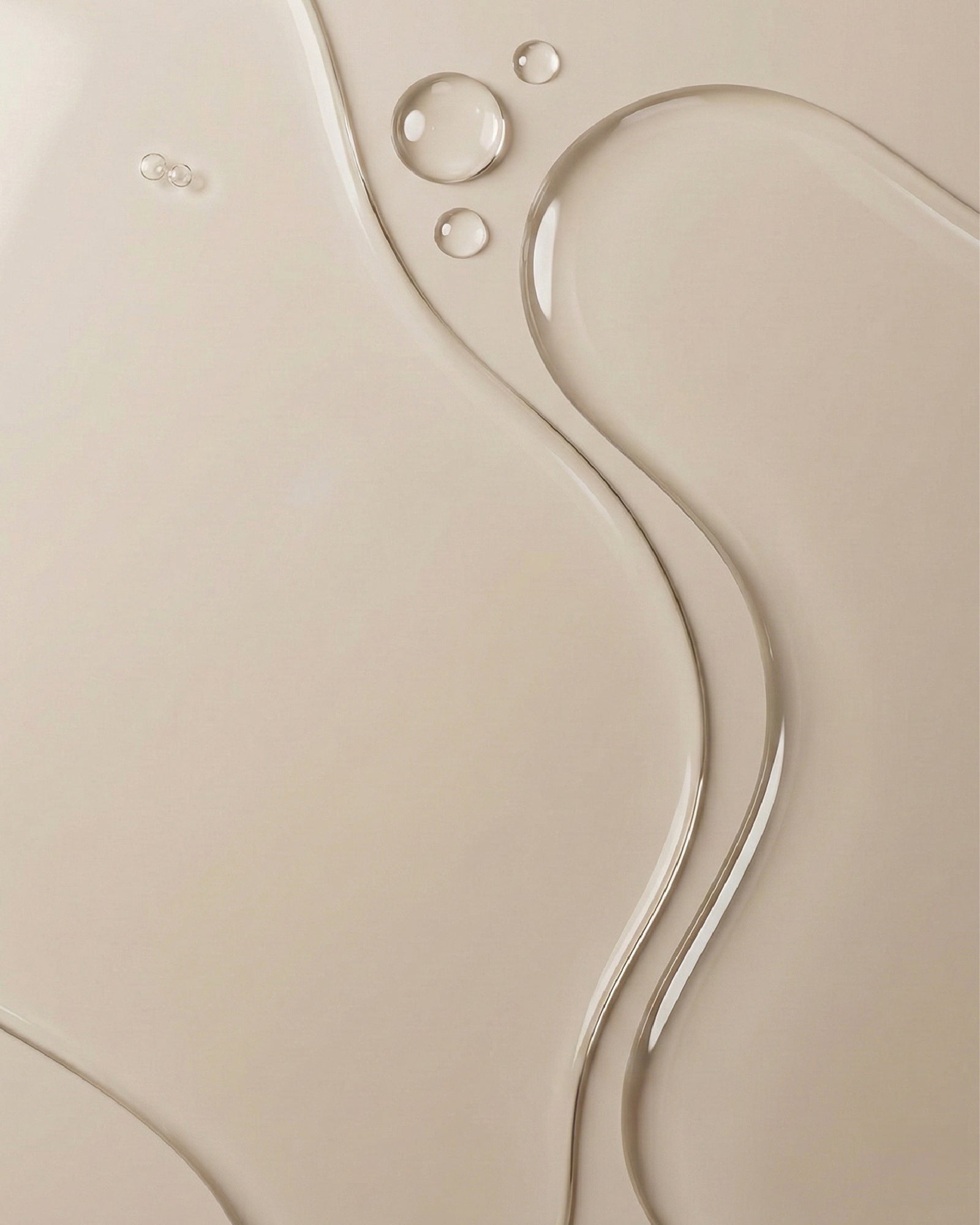 Close up image showing the liquid texture of Glycolic Exfoliating Toner on beige surface
