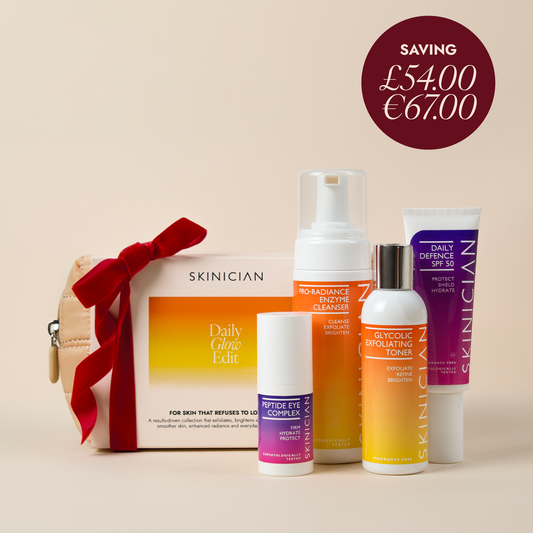 Skinician Daily Glow Edit skincare gift set on a warm beige background with a red ribbon. Image features a dark red circular price tag overlay in the top right that reads "Saving £54 / €67