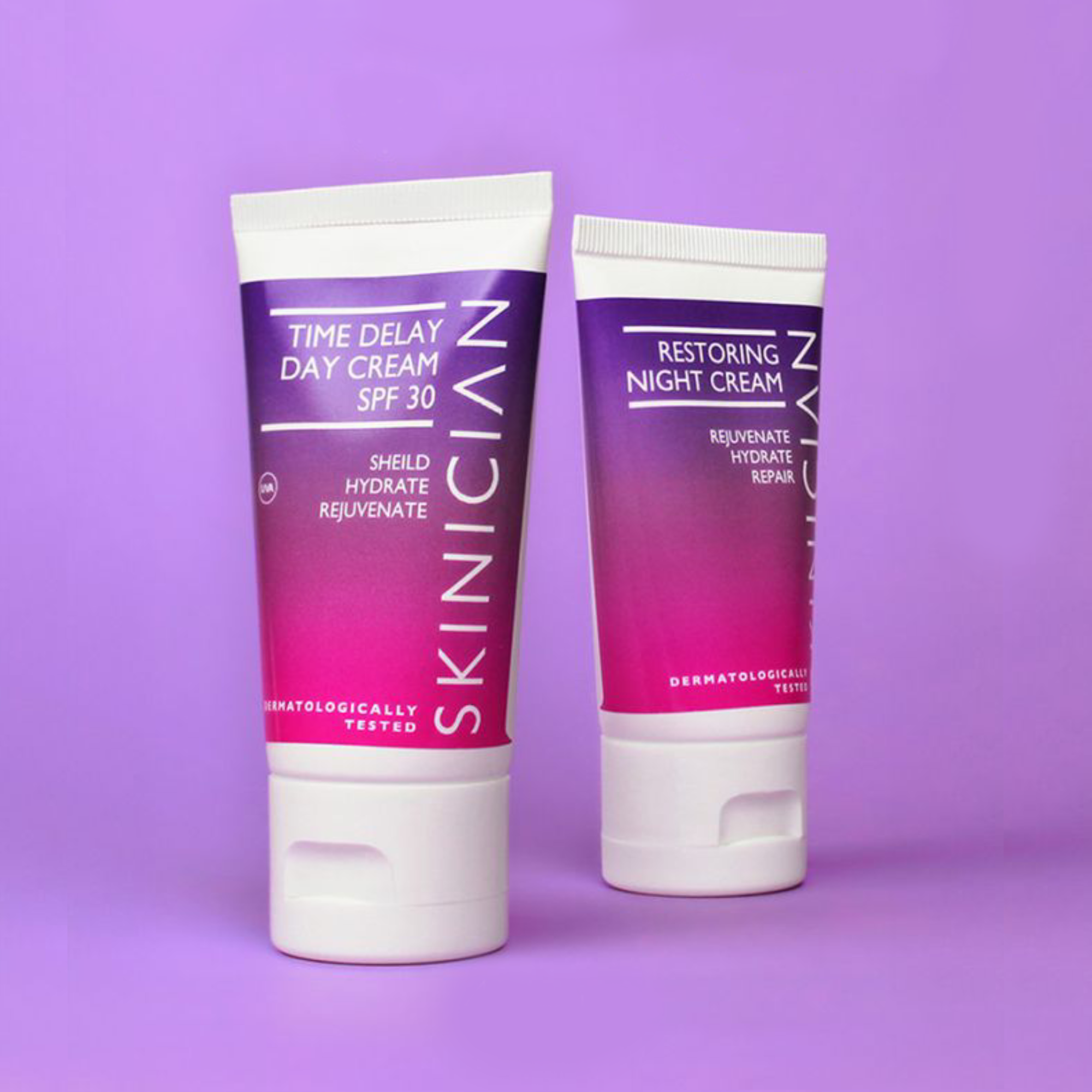 Image of Skinician Time Delay Day Cream and Restoring Night Cream tubes on a purple background