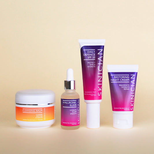 Image of Skinician Cleansing Balm, Hyaluronic Elixir, Daily Defence SPF 50 and Restoring Night Cream on cream background