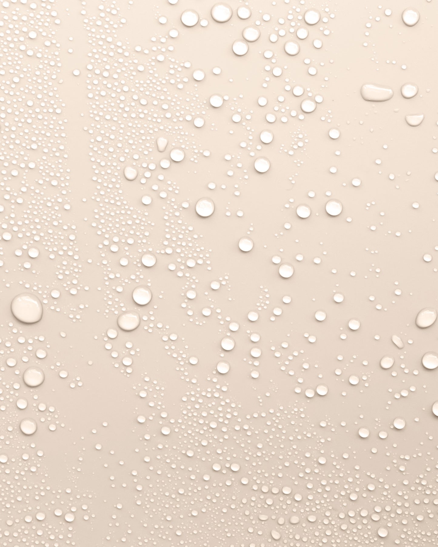 Beige background with water droplets to represent the texture of Revitalising Toner