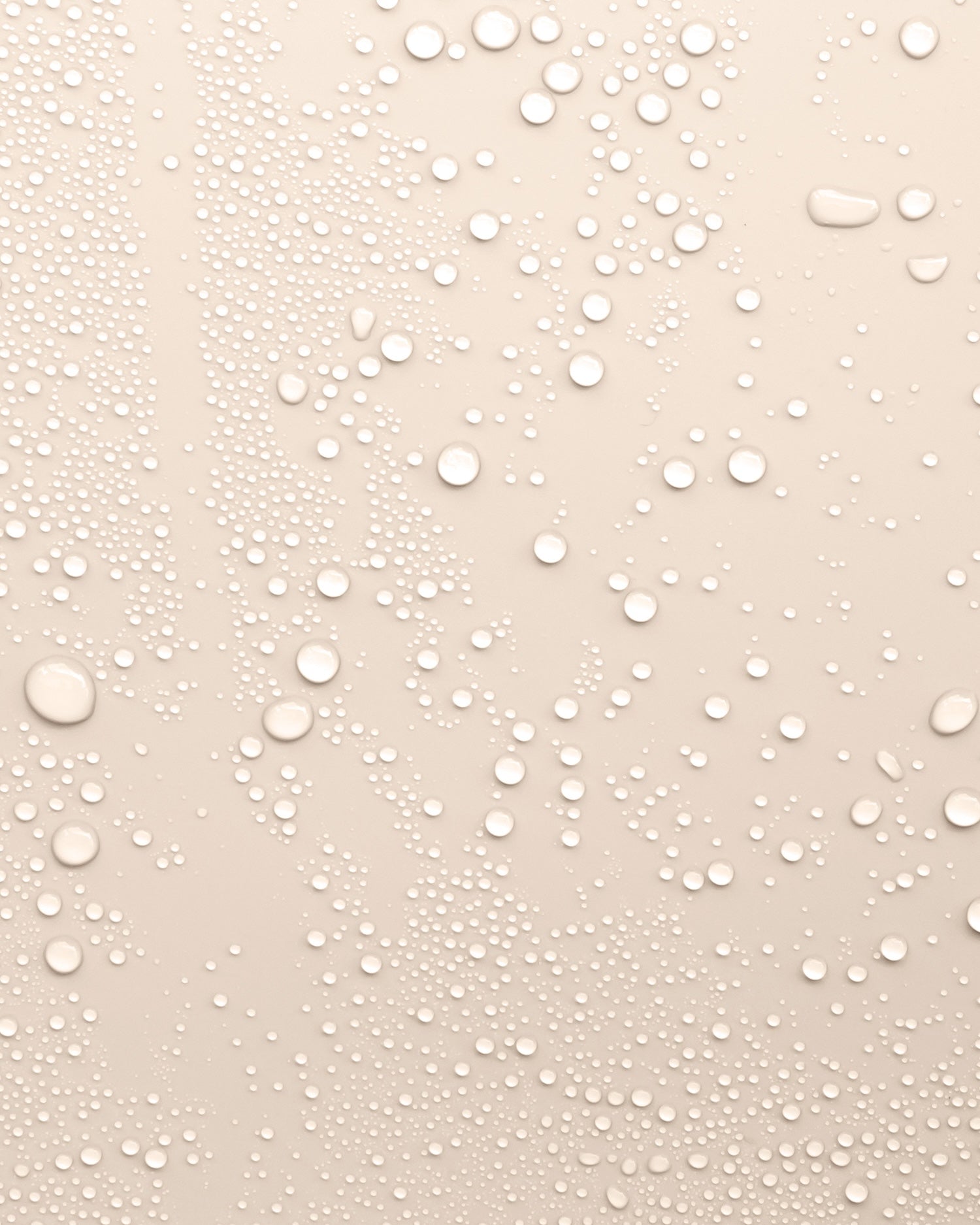 Beige background with water droplets to represent the texture of Revitalising Toner
