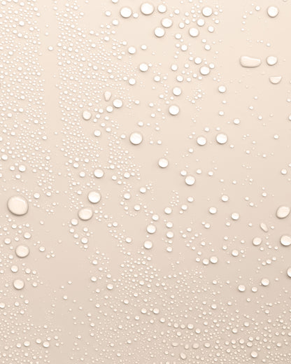 Beige background with water droplets to represent the texture of Revitalising Toner