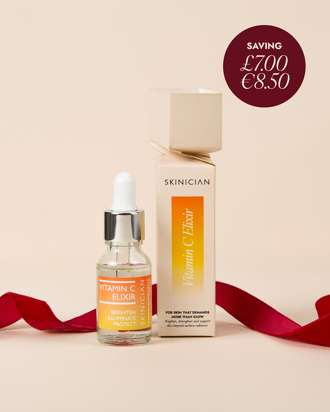 Skinician Vitamin C Elixir cracker on beige background with red ribbon. Image features roundel with product savings.
