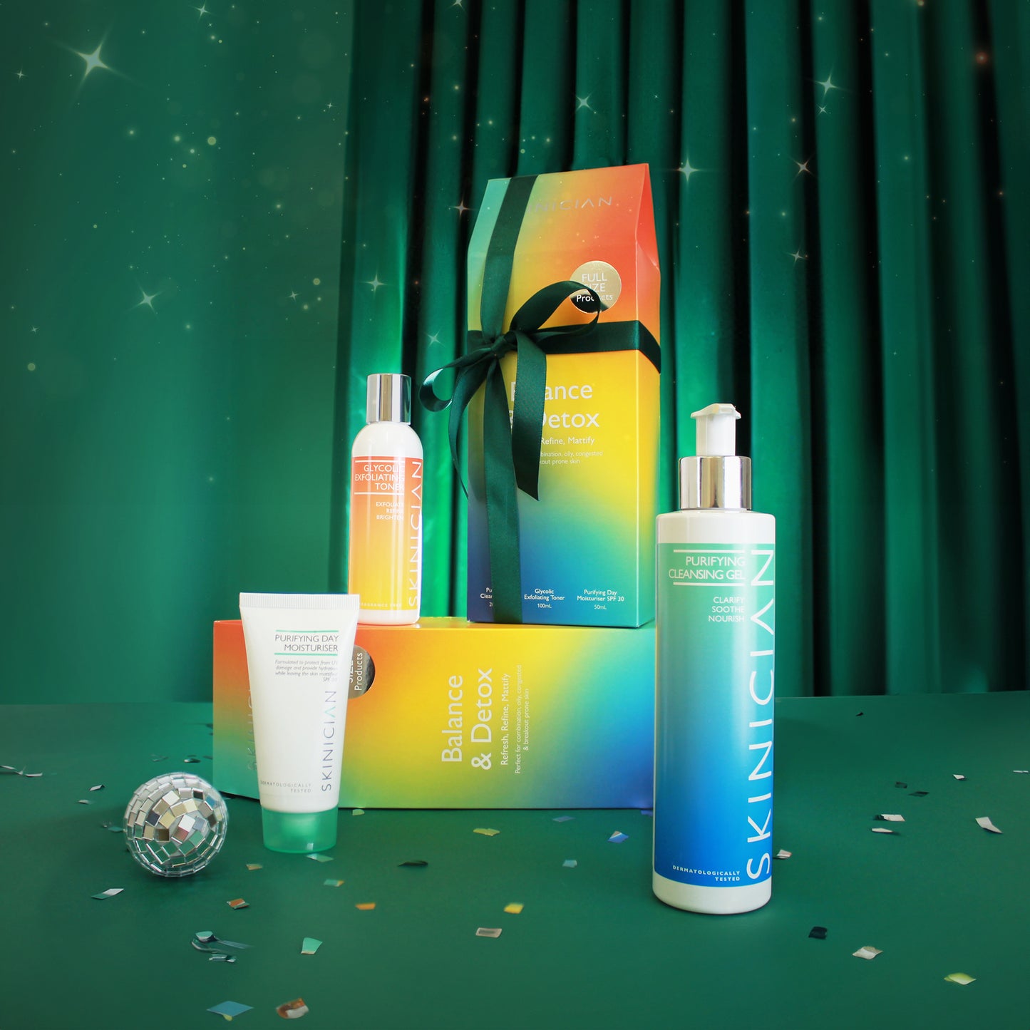Skinician Balance and Detox Gift set showcasing skincare set packaging with products on display, staged on a velvet green, christmas themed backdrop