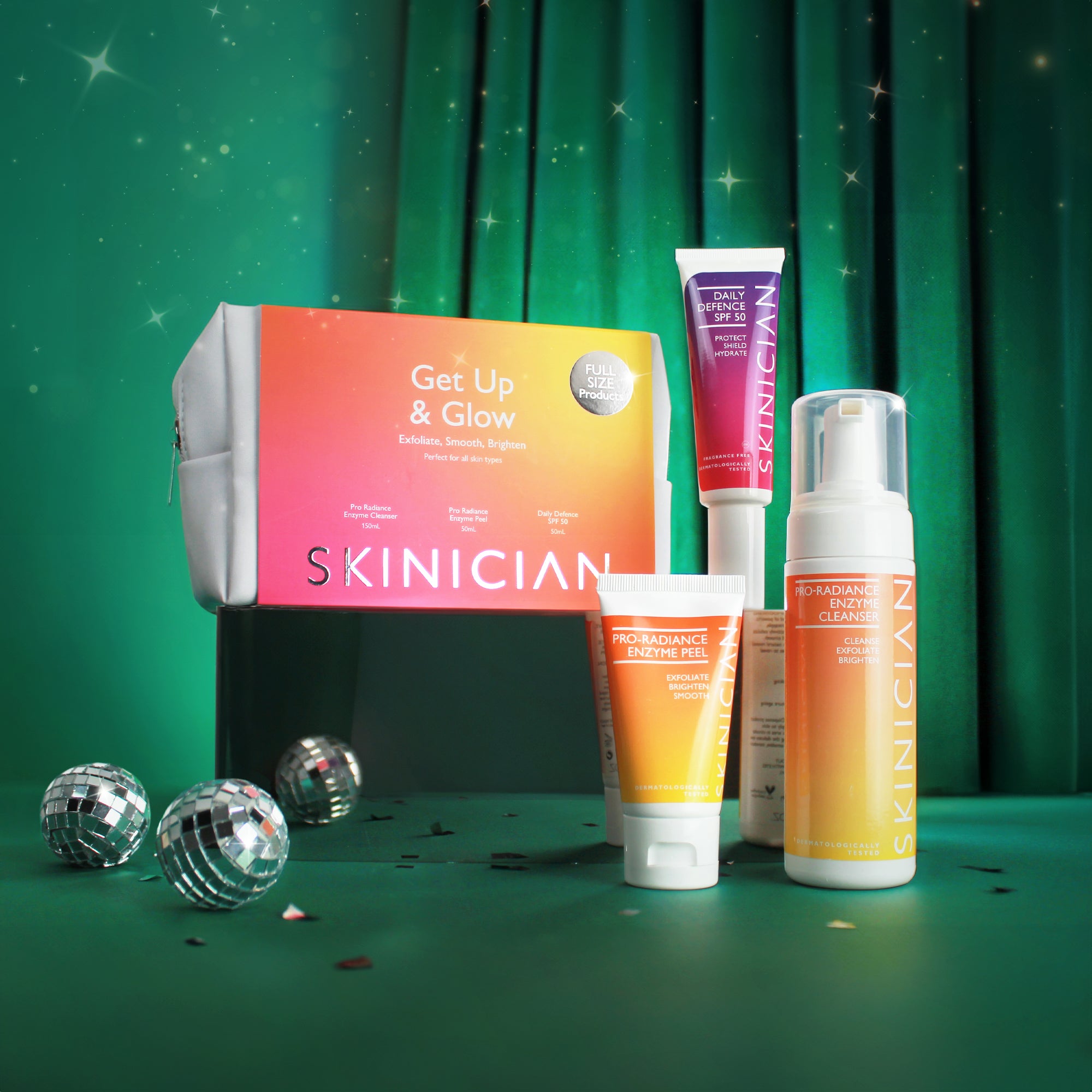 Skinician Get up + Glow gift set showcasing packaging and products on display, set on a luxurious green velvet, Christmas themed backdrop