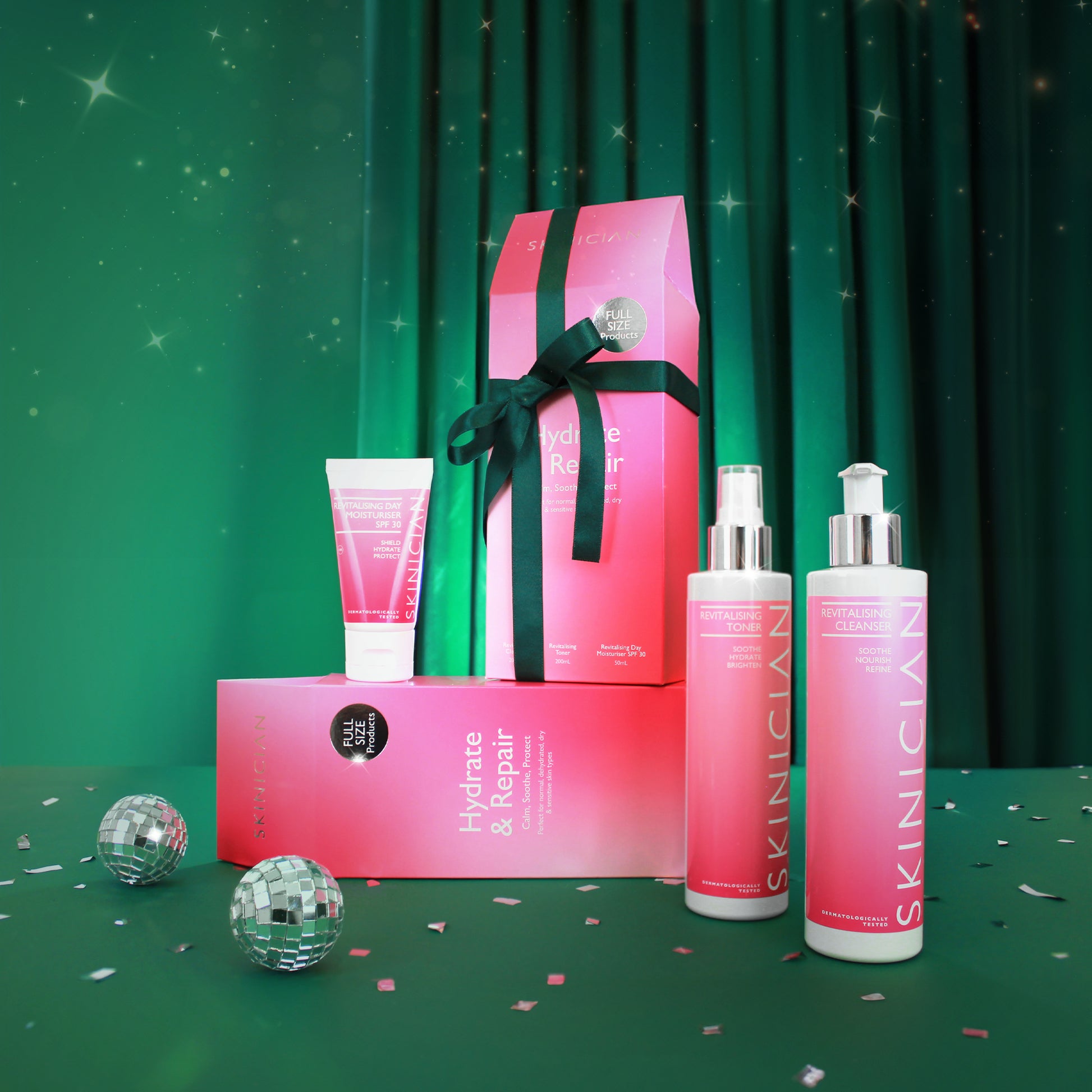 Skinician Hydrate and Repair giftset showcasing Christmas packaging with products on display, on a green velvet, christmas themed backdrop