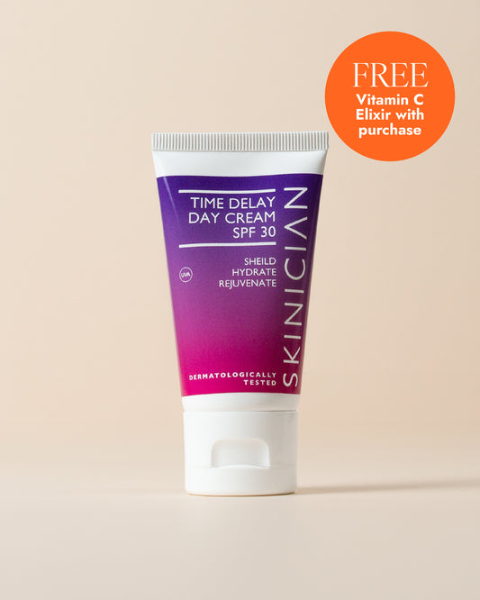 Tube of Skinician Time Delay Day Cream SPF 30 on a beige background with a free Vitamin C Elixir offer.