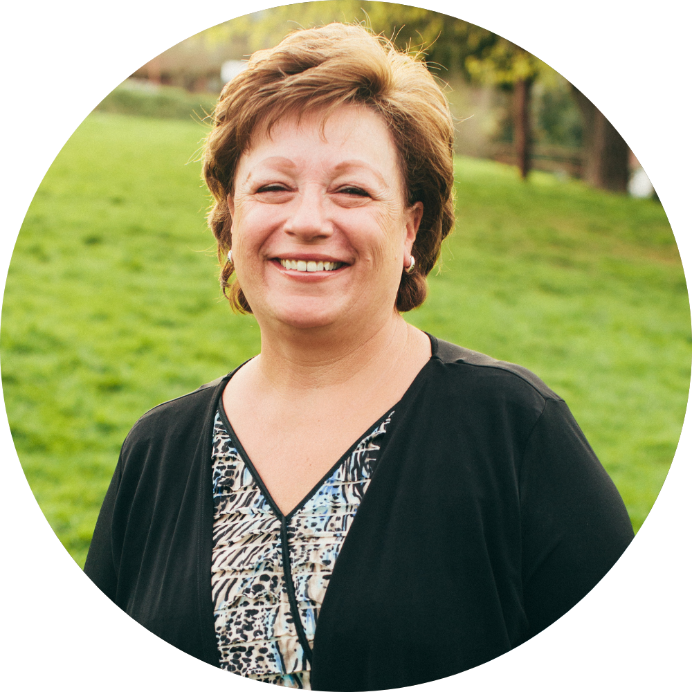 Round image of middle-aged woman smiling to represent Skinician customer
