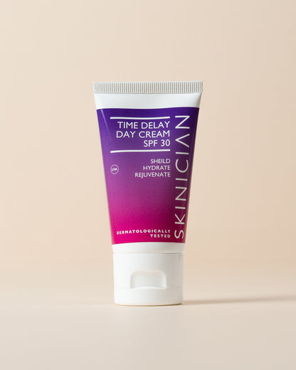 Tube of Skinician Time Delay Day Cream SPF 30 on a beige background