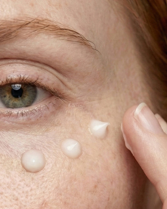 Close-up of a person applying cream to their face