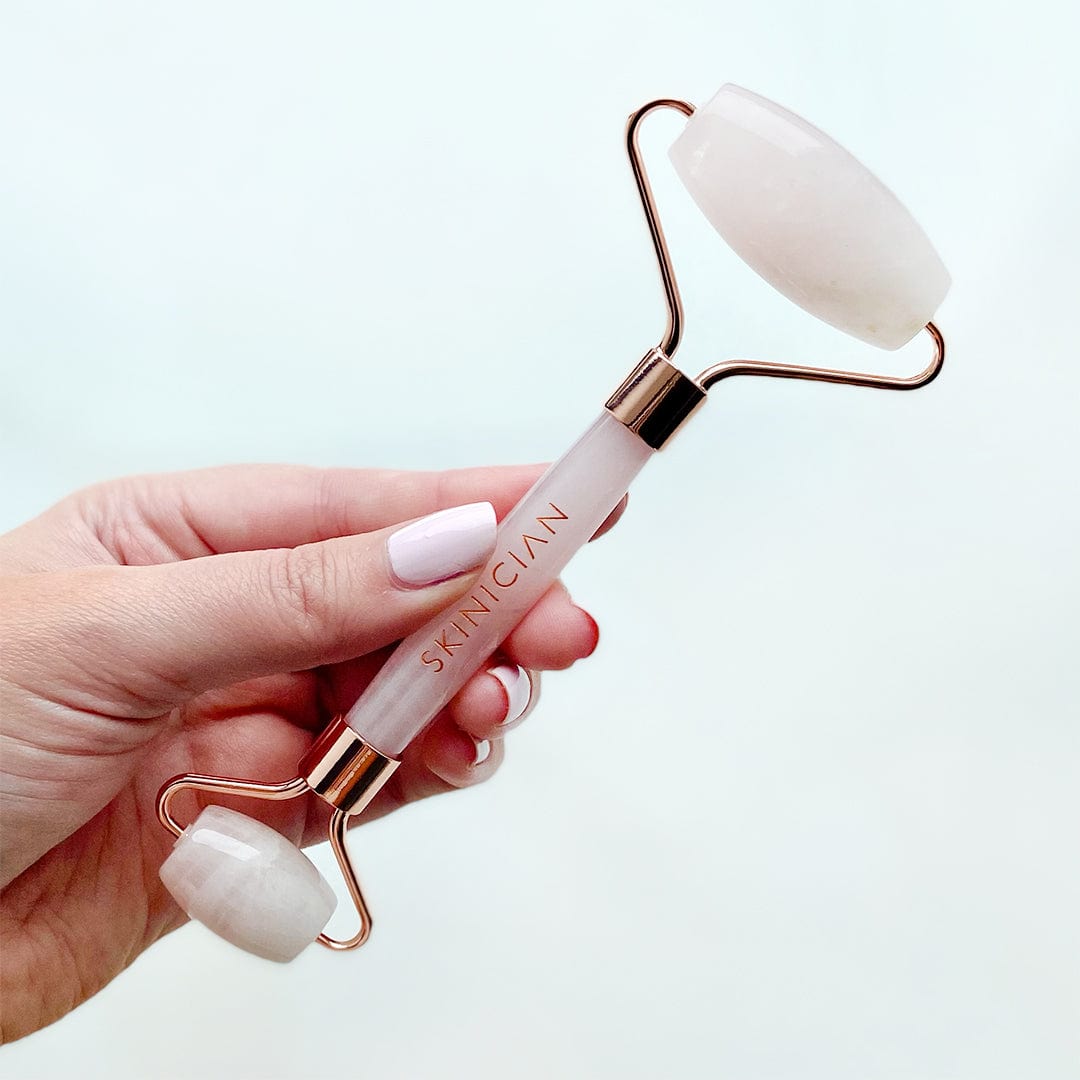 Skinician's Rose Quartz Roller being held by a lady - double sided rollers