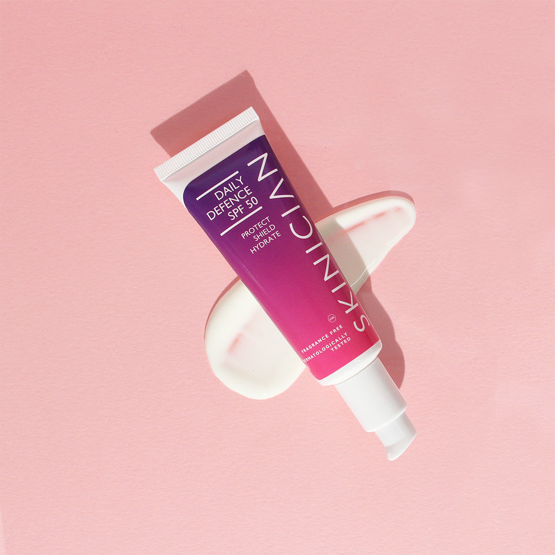 image of Skinician Daily Defence SPF 50 moisturiser on top of liquid on pink background